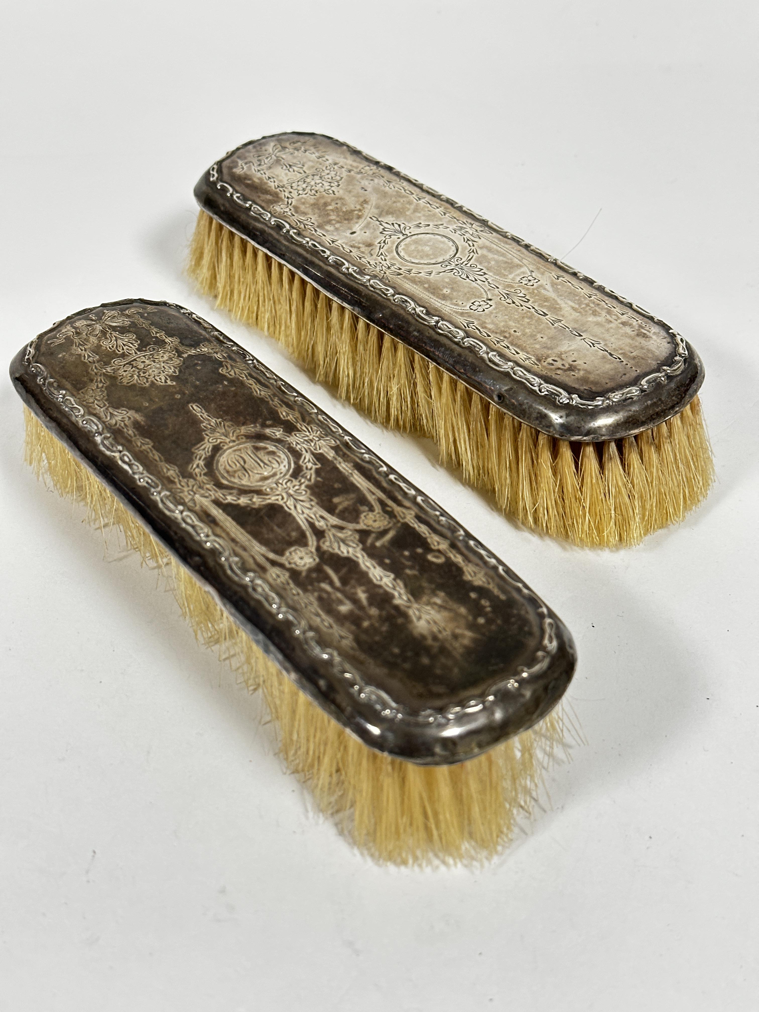 A pair of Edwardian Birimgham 1912 silver engraved backed hairbrushes of rectangular form, one