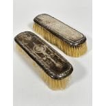 A pair of Edwardian Birimgham 1912 silver engraved backed hairbrushes of rectangular form, one