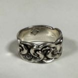 A silver cast ring with scrolling interlocking panel to front (h: 0.5cm x 2cm) (Q/R) stamped 925