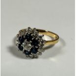 An 18ct gold sapphire and diamond cluster ring, the centre stone approximately 0.2ct, with