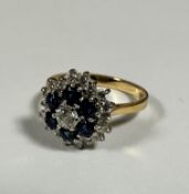 An 18ct gold sapphire and diamond cluster ring, the centre stone approximately 0.2ct, with