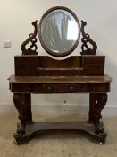 A Victorian mahogany Duchess wash stand, the swing mirror over an arrangement of trinket drawers,