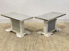 A pair of low tables, each with sectional mirrored glass tops raised on white and grey painted