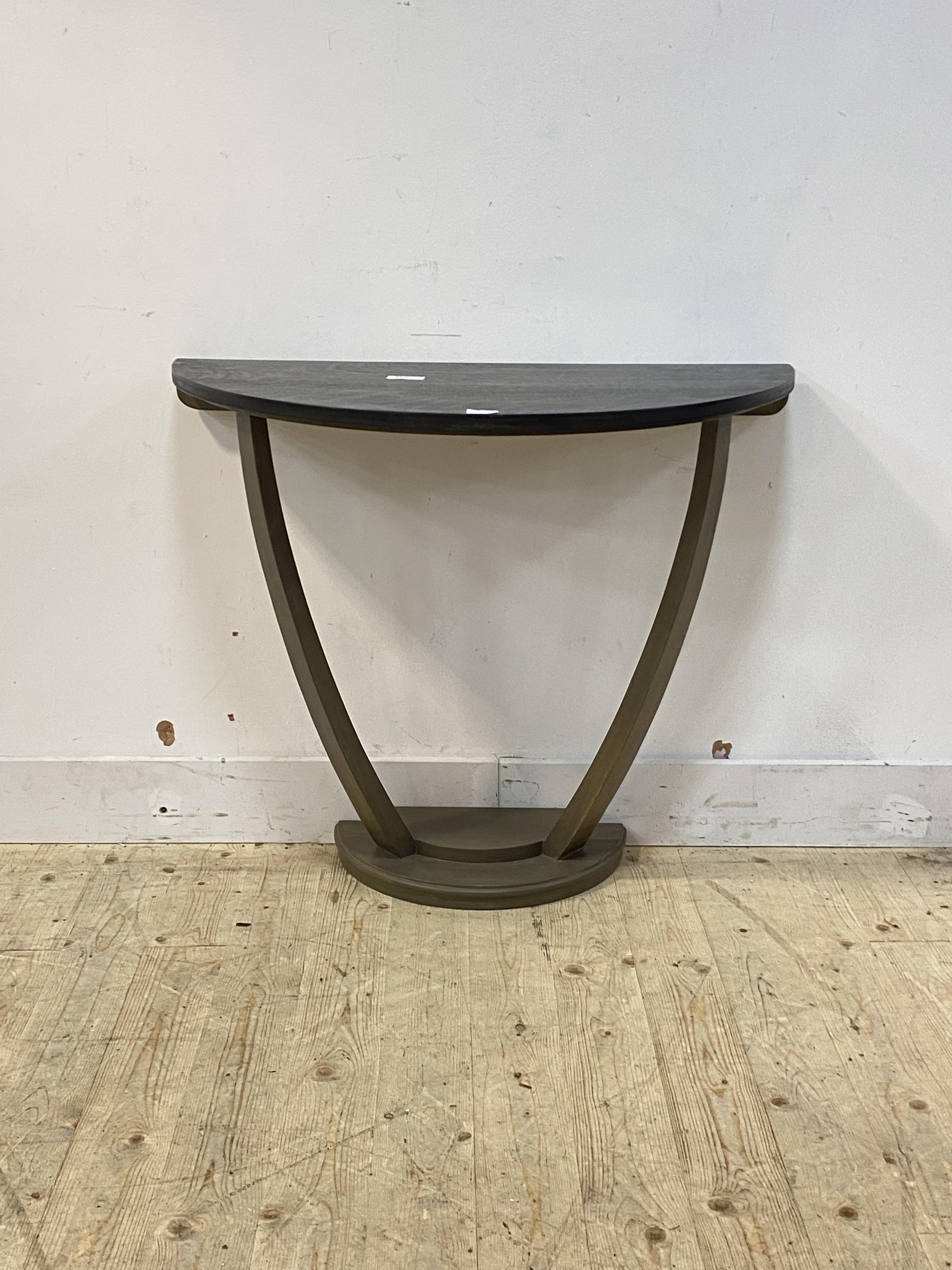 A painted hardwood demi-lune console table, the top raised on bowed stretchers, H77cm, W90cm, D48cm