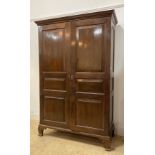 A 19th century mahogany combination press wardrobe the dentil cornice over twin panelled doors,