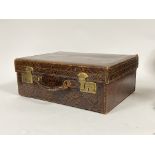 A 1930's snakeskin overnight case, with leather carry handle and silk lined interior H17cm, W46cm,