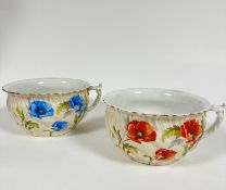 A pair of Limoges porcelain chamber pots, one decorated with blue poppies the other with red