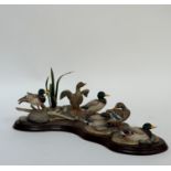 A Border Fine Arts figure of six mallard ducks in various positions on a pebbled bank. (loss to