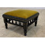 An Aesthetic period ebonised footstool with upholstered top, spindle apron and turned supports, with