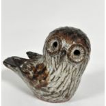 J K, pottery moulded figure of a seated owl with inset hollowed eyes, (h: 15cm x 17cm)