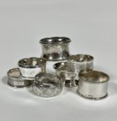 Two Edwardian style silver circular engraved napkin rings, a heavy Birmingham silver napkin ring