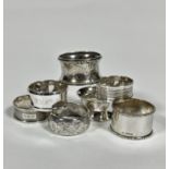 Two Edwardian style silver circular engraved napkin rings, a heavy Birmingham silver napkin ring