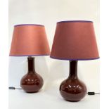 A pair of Pooky Sang-de-Boeuf glazed Chinese style slim necked baluster vase lamps, complete with