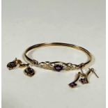 A 9ct gold stiff hinged bangle set oval amethyst in open work setting, (6.5cm x 5cm) and two pairs