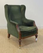 A good mid 19th century mahogany framed wingback armchair, upholstered in bottle green corduroy,