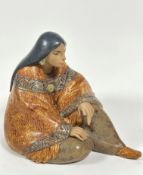 A Spanish Lladro porcelain figure of seated Mexican lady draped with shawl and wearing moccasins,