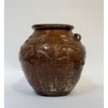 An East Asian treacle glaze earthenware pot with decoration of three-toed dragons in relief, with