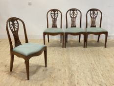 A set of four Georgian Hepplewhite design mahogany dining chairs, the moulded hooped back with