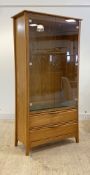 Ercol, a late 20th century blonde elm bookcase display cabinet, two glazed doors enclosing an