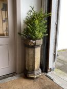 A Victorian terracotta chimney pot of faceted octagonal form, plated with a common box tree