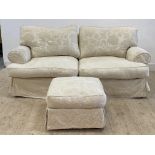 A traditional two seat sofa, upholstered in a fitted white damask cover, raised on turned bun