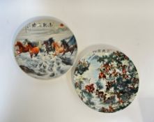 A pair of modern Chinese ceramic chargers, one with a polychrome printed design depicting