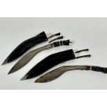 Two steel bladed Kukri ebony handled knives complete with miniature knives, all show signs of