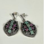 A pair of Continental white metal shield shaped pendant earrings with marcasite borders and gem
