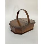 A Regency mahogany sewing box of tapered octagonal outline, the bentwood handle over two brass