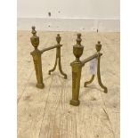 A pair of Edwardian cast brass andirons, each decorated with urn finial and ribbon and hare bells,