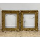 A pair of gilt composition picture frames in the Rococo taste, aperture 39cm x 49cm