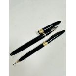 A Sheaffer yellow metal mounted black plastic cased fountain pen complete with white metal nib (L: