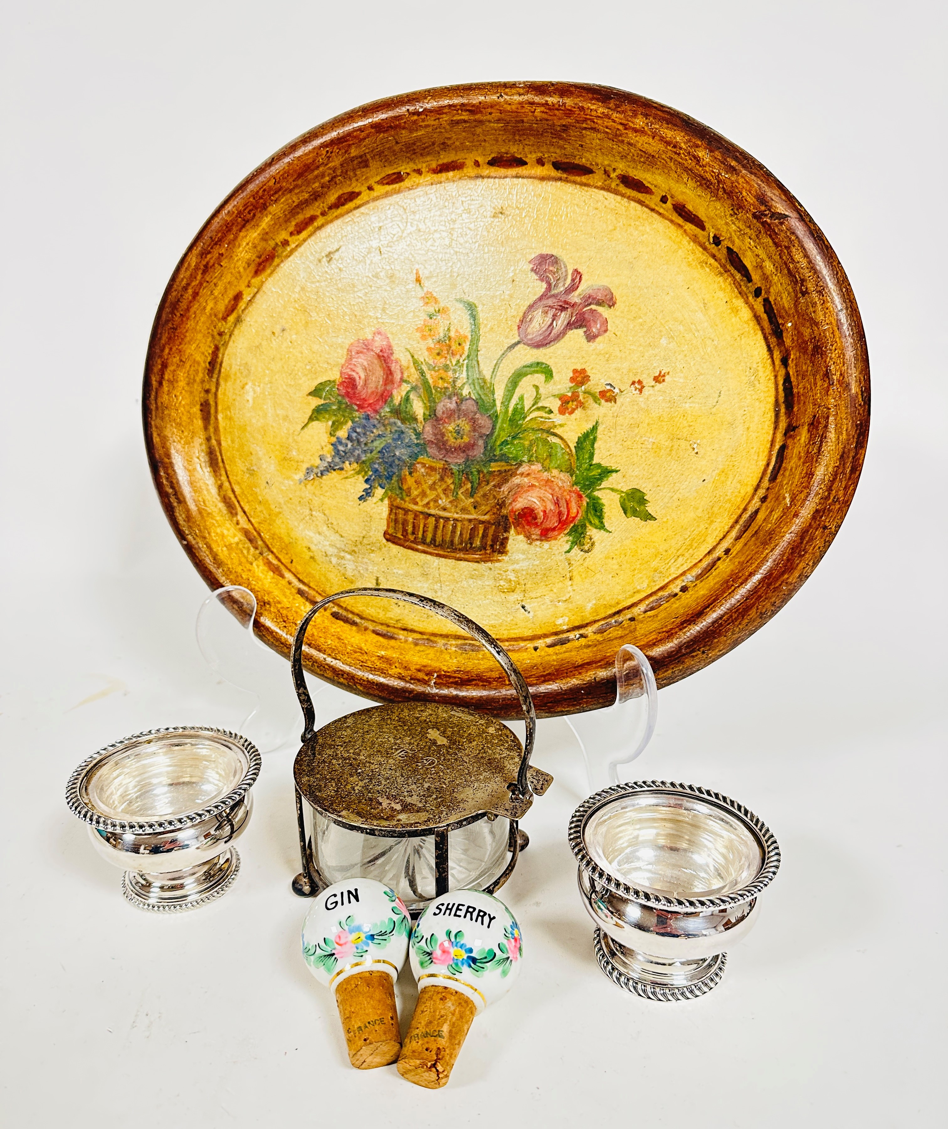 An Italian style papier mache oval tray with hand painted basket of flowers, (37cm x 30cm) an Epns