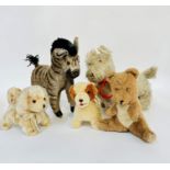 A group of stuffed toys including a vintage zebra with striped plush coat with taped hooves, (H;