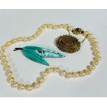 A cultured strand of pearls with 9ct gold clasp fastening set oval citrine with surround of eight