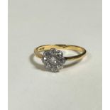 A 9ct gold diamond cluster ring the centre mixed cut stone in millegrain setting with surround of