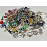 A collection of silver brooches, silver pendants, a silver graduated agate brooch, a glass oval