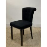 A contemporary accent chair, upholstered in buttoned and studded grey velvet, raised on ebonised