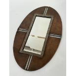 An abstract copper oval wall mounted mirror (h- 60.5cm w- 37.5cm)