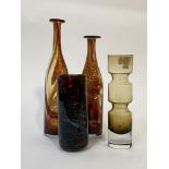 A group of art glass comprising a pair of red/brown Mdina blown bottle vases (tallest H36cm,