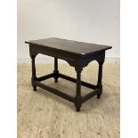 An 18th century oak side table of pegged and jointed construction, with channelled frieze over