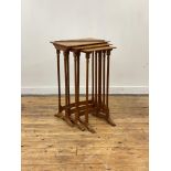 An early 19th century satinwood nest of three tables, each top with ebony sting inlay, raised on