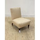 A Victorian nursing chair, upholstered in ivory damask, moving on castors, H67cm