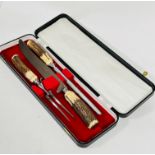 A case containing 3 piece horn handled carving set including knife, steel and fork