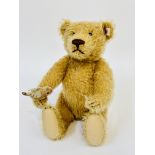 A modern Steiff German plush mohair bear with inset glass black bead eyes, stitched nose and