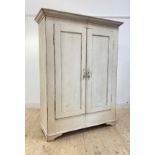 A late 19th century French white painted pine armoire, the projecting cornice over two panelled