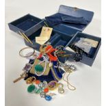 A blue leather vintage jewellery case with fold out concertina sections containing pink coral