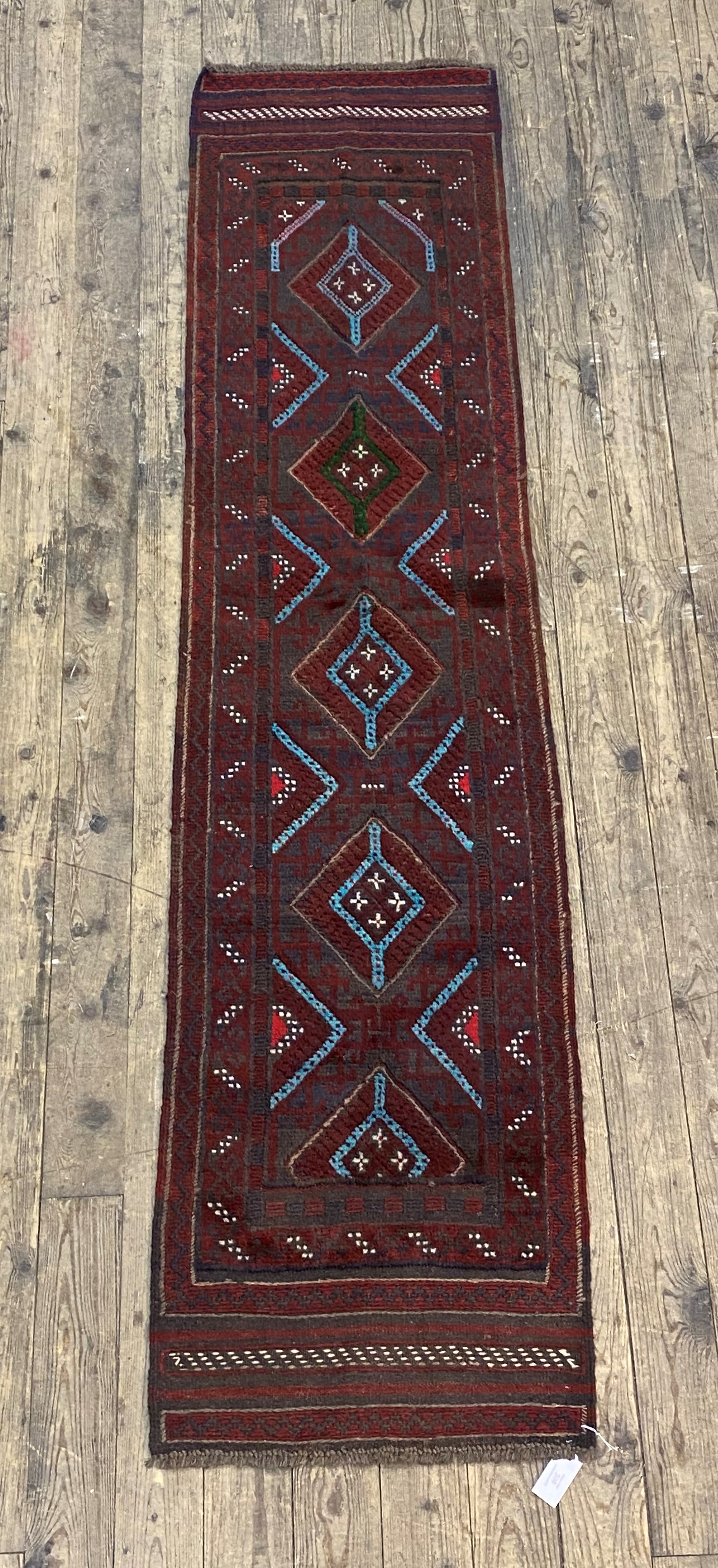 A Meshwani runner rug of typical design, 252cm x 60cm
