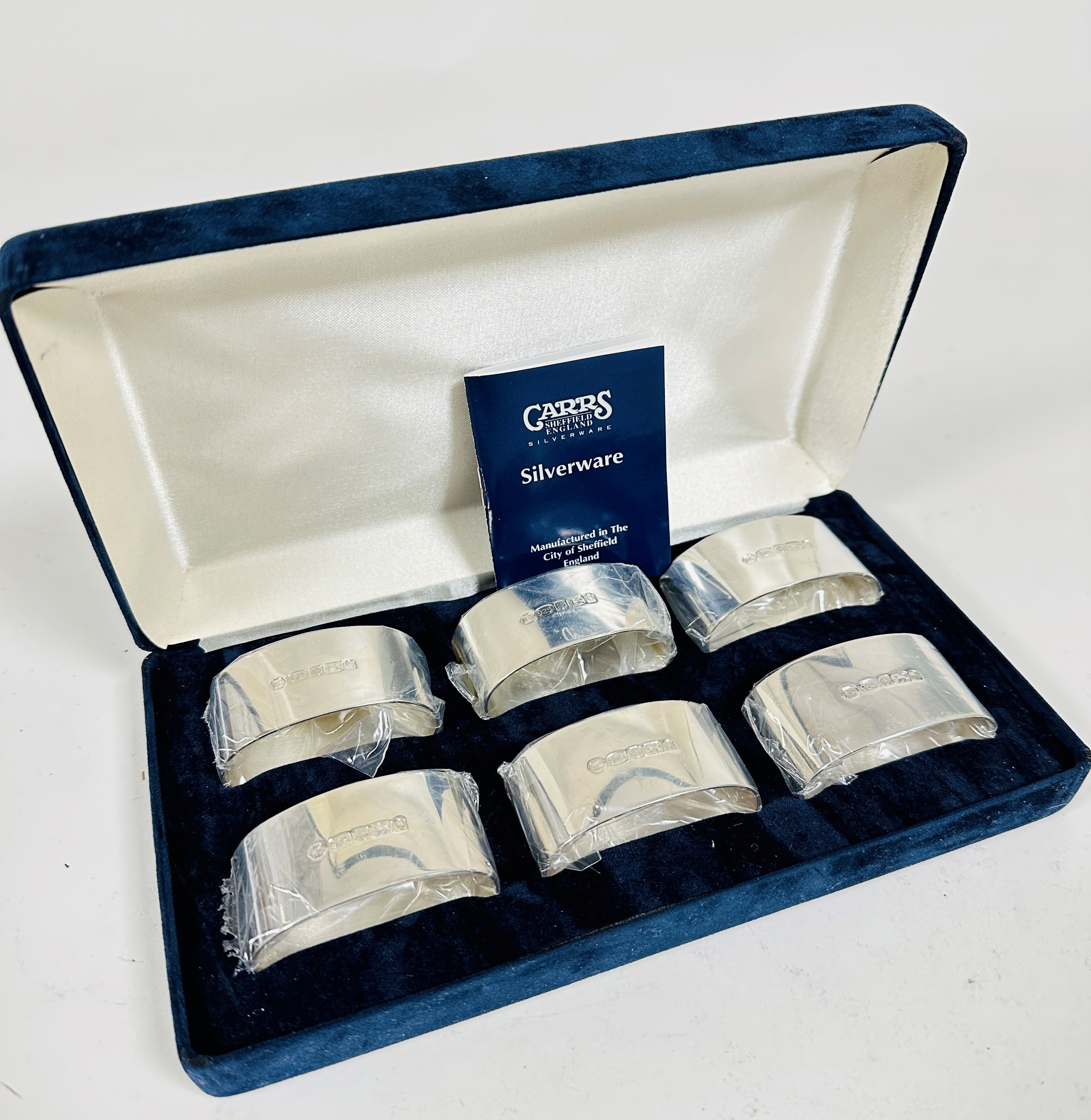 A set of six silver Queen Elizabeth II oval napkin rings in presentation box, with original sealed