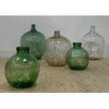 A collection of five glass demijohns, largest H64cm